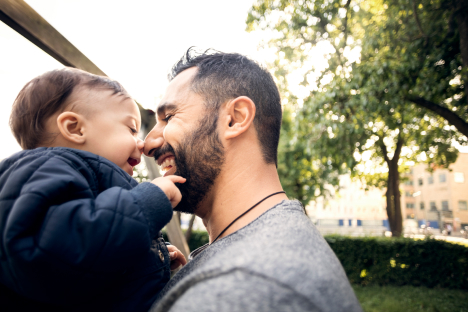 Dad and toddler embracing each other